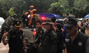 Thai military personnel and rescuers are seen outside the Tham Luang caves, where 13 members of an-under 16 soccer team are trapped, in the northern province of Chiang Rai, Thailand, June 25, 2018. REUTERS/Stringer
