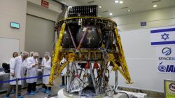 Israeli scientists stand next to an unmanned spacecraft which an Israeli team plans to launch into space at the end of the year and to land it on the Moon next year, in Yahud, Israel, July 10, 2018 REUTERS/Ronen Zvulu