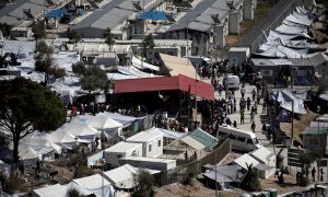 FILE PHOTO: Refugees and migrants line up for food distribution at the Moria migrant camp on the island of Lesbos, Greece October 6, 2016. REUTERS/Alkis Konstantinidis/File Photo