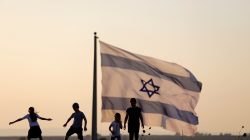 FILE PHOTO - Israeli kids play next to an Israeli flag next to the Israeli Syrian border at the Israeli-occupied Golan Heights, Israel July 23, 2018. REUTERS/Ronen Zvulun