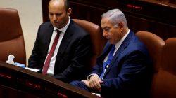 FILE PHOTO: Israeli Prime Minister Benjamin Netanyahu sits next to Israeli Education Minister Naftali Bennett during a session of the plenum of the Knesset, the Israeli Parliament, in Jerusalem, March 12, 2018. REUTERS/Ronen Zvulun/File Photo
