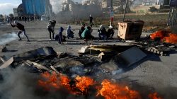 Palestinians take cover during clashes with Israeli troops near the Jewish settlement of Beit El, near Ramallah, in the Israeli-occupied West Bank December 13, 2018. REUTERS/Mohamad Torokman
