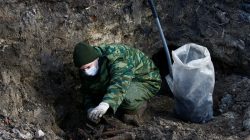 A soldier from a special "search battalion" of Belarus Defence Ministry takes part in the exhumation of a mass grave containing the remains of about 730 prisoners of a former Jewish ghetto, discovered at a construction site in the centre of Brest, Belarus February 26, 2019. REUTERS/Vasily Fedosenko