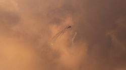 An Israeli Apache helicopter releases flares as it flies over the Gaza Strip March 25, 2019. REUTERS/Mohammed Salem