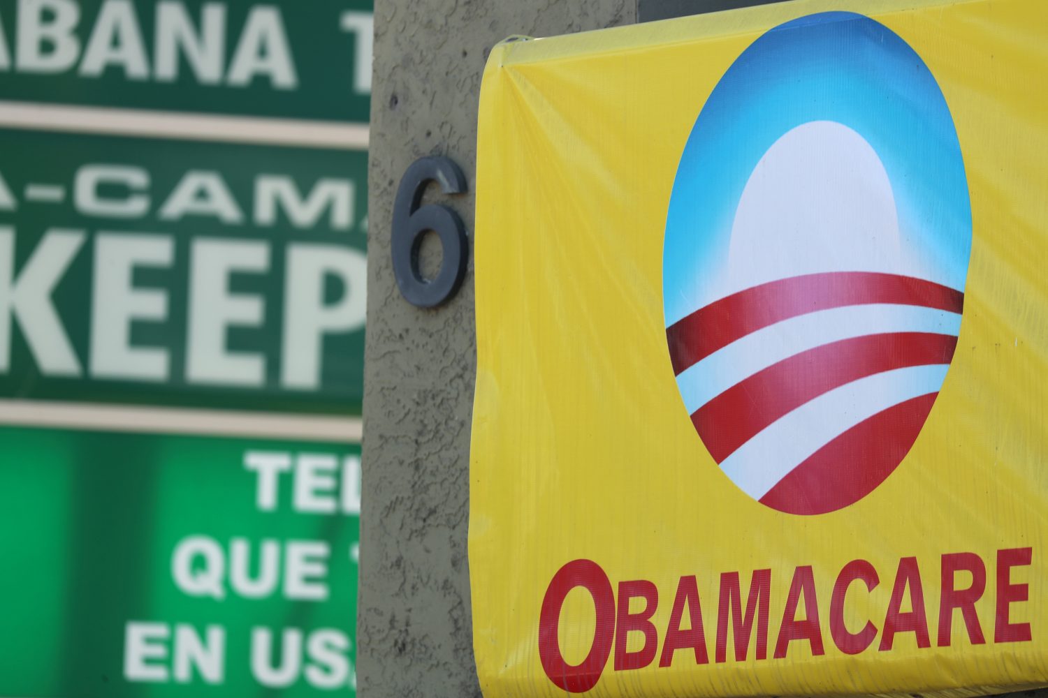 FILE PHOTO - A sign on an insurance store advertises Obamacare in San Ysidro, San Diego, California, U.S., October 26, 2017. REUTERS/Mike Blake