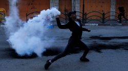 A Palestinian protester returns a tear gas canister fired by Israeli troops during clashes in Hebron, in the occupied West Bank March 29, 2019. REUTERS/Mussa Qawasma