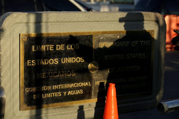 A U.S. Customs and Border Protection (CBP) agent cast his shadow on a plaque marking the boundaries of Mexico and United States, at Paso del Norte international border crossing bridge, in Ciudad Juarez, Mexico April 1, 2019. REUTERS/Jose Luis Gonzalez