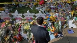 FILE PHOTO: A man prays at a makeshift memorial outside the Tree of Life synagogue following Saturday's shooting at the synagogue in Pittsburgh, Pennsylvania, U.S., October 31, 2018. REUTERS/Cathal McNaughton/File Photo