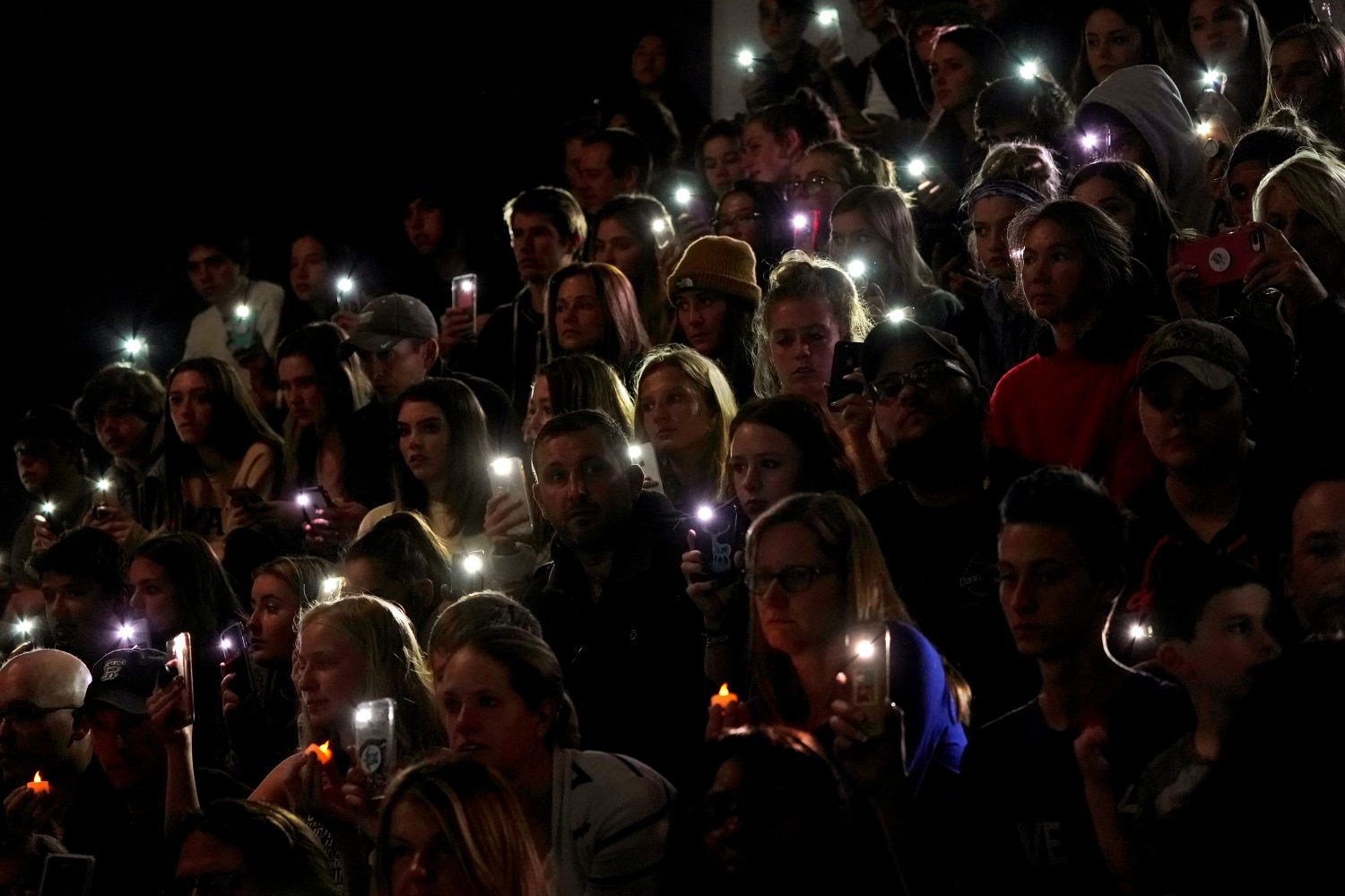 People hold up the phone lights during a moment of silence at a vigil for the victims of the shooting at the Science, Technology, Engineering and Math (STEM) School in Highlands Ranch, Colorado, U.S., May 8, 2019 as U.S. Sen. Michael Bennett (D-CO) speaks. REUTERS/Rick Wilking