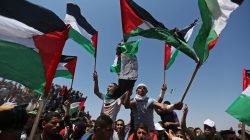 Demonstrators hold Palestinian flags during a protest marking the 71st anniversary of the 'Nakba', or catastrophe, when hundreds of thousands fled or were forced from their homes in the war surrounding Israel's independence in 1948, near the Israel-Gaza border fence, in the southern Gaza Strip May 15, 2019. REUTERS/Ibraheem Abu Mustafa