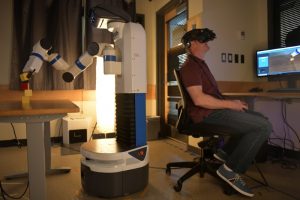 University of Colorado Boulder PhD student Dan Prendergast participates in an experiment to test whether he operates a robot better in 2D or virtual reality at a lab in Boulder, Colorado, U.S., June 24, 2019. The team's findings may help determine what camera systems will be implemented on robots destined to perform tasks on the moon. REUTERS/Michael Ciaglo