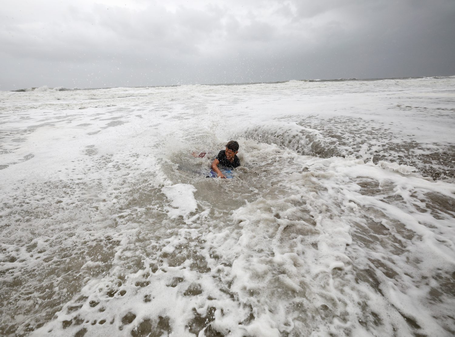 Nathan Piper, 11, is swamped by increasingly rough waves while body surfing as Hurricane Dorian approaches, in Carolina Beach, North Carolina, U.S., September 5, 2019. REUTERS/Jonathan Drake