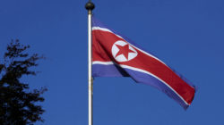 FILE PHOTO: A North Korean flag flies on a mast at the Permanent Mission of North Korea in Geneva October 2, 2014. REUTERS/Denis Balibouse/File Picture