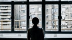 Girl looking out Window